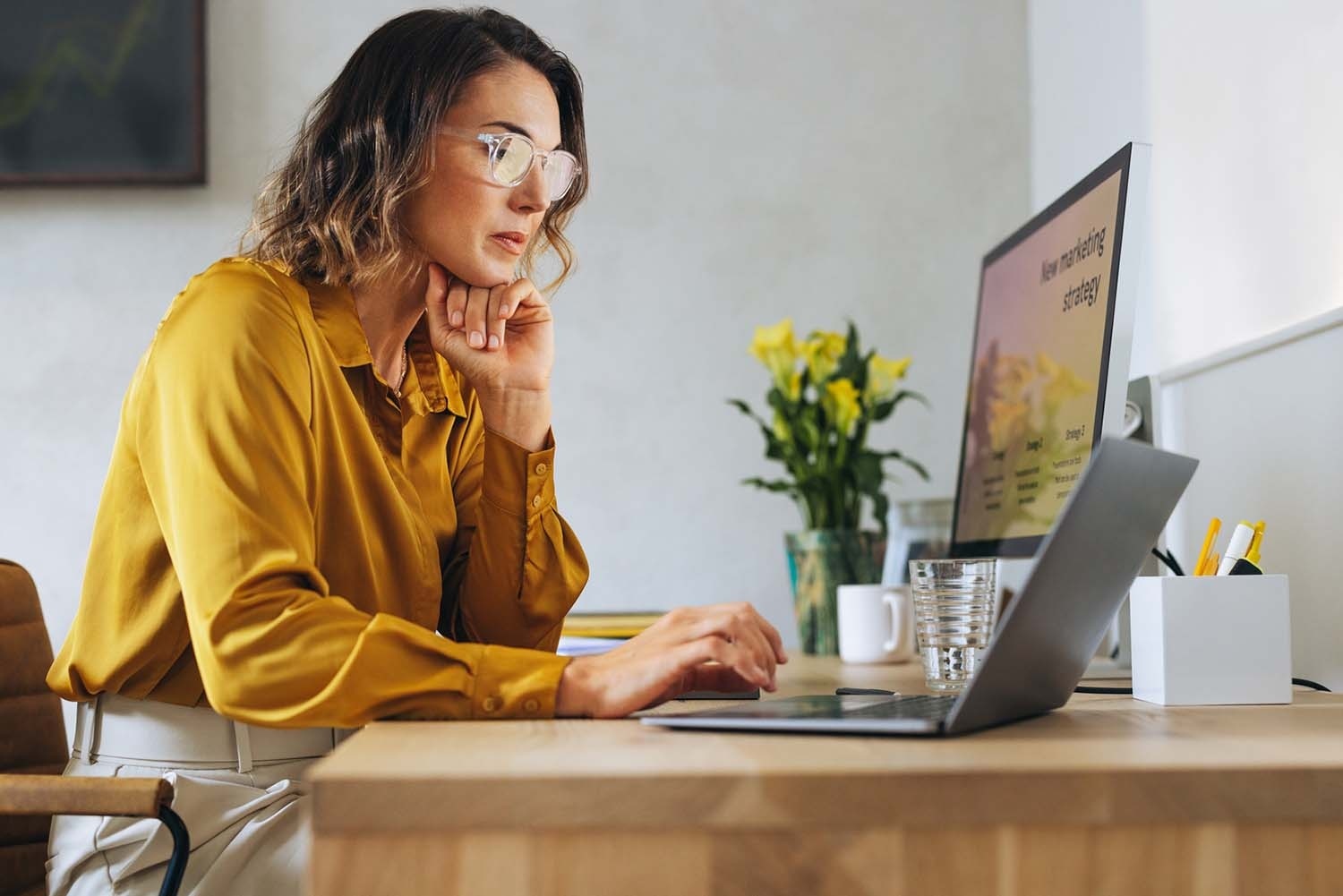 Woman on laptop planning targeted digital advertising strategies, navigating the evolving ad landscape.